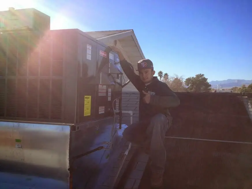 HVAC technician performing Boiler Repair on a rooftop unit in Fort Oglethorpe